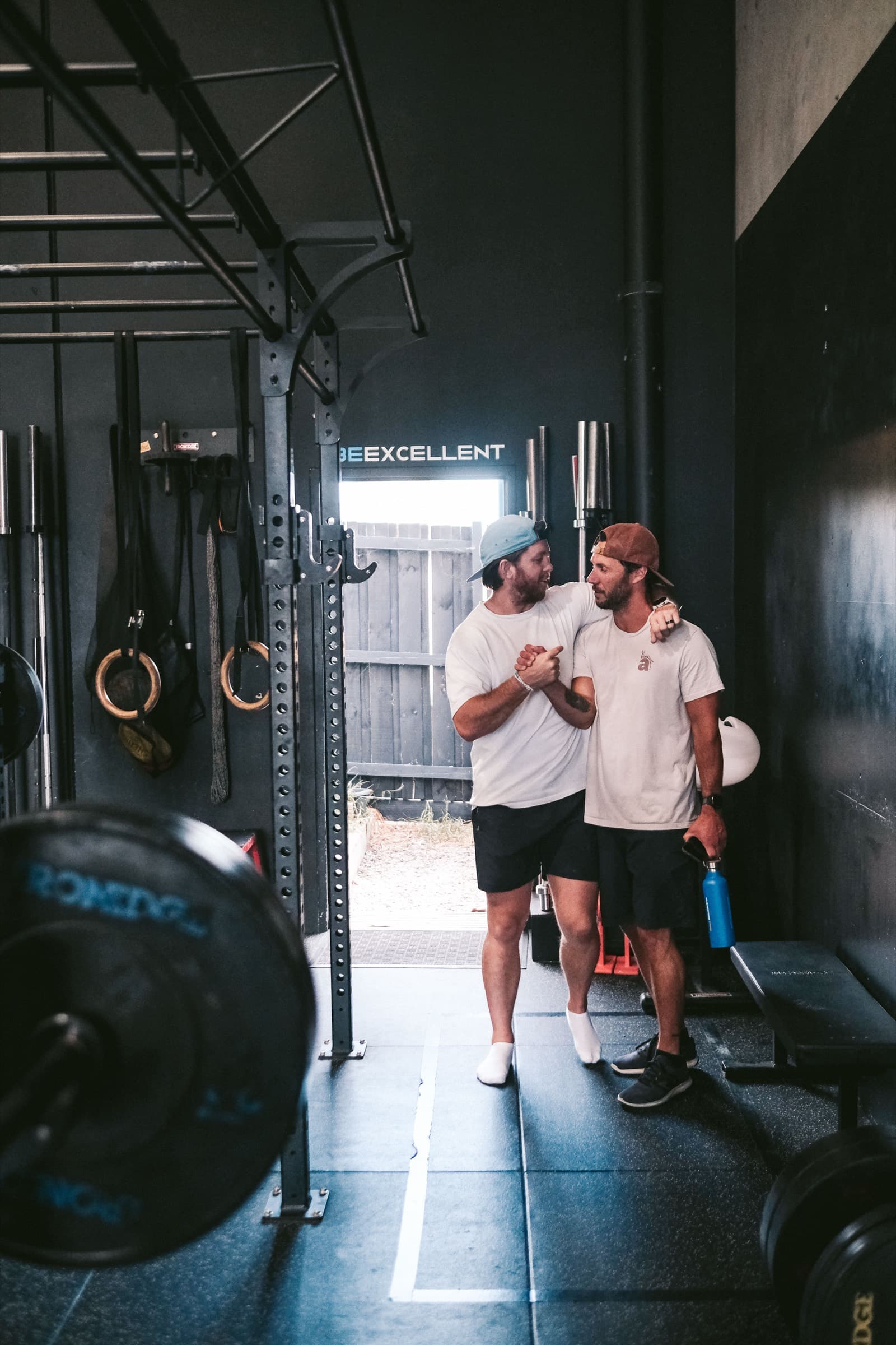 A coach and member sharing a relaxed moment on the Virtus Performance floor