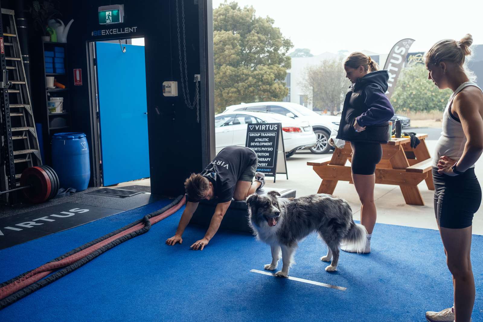 Floor stretches with a border collie supervising