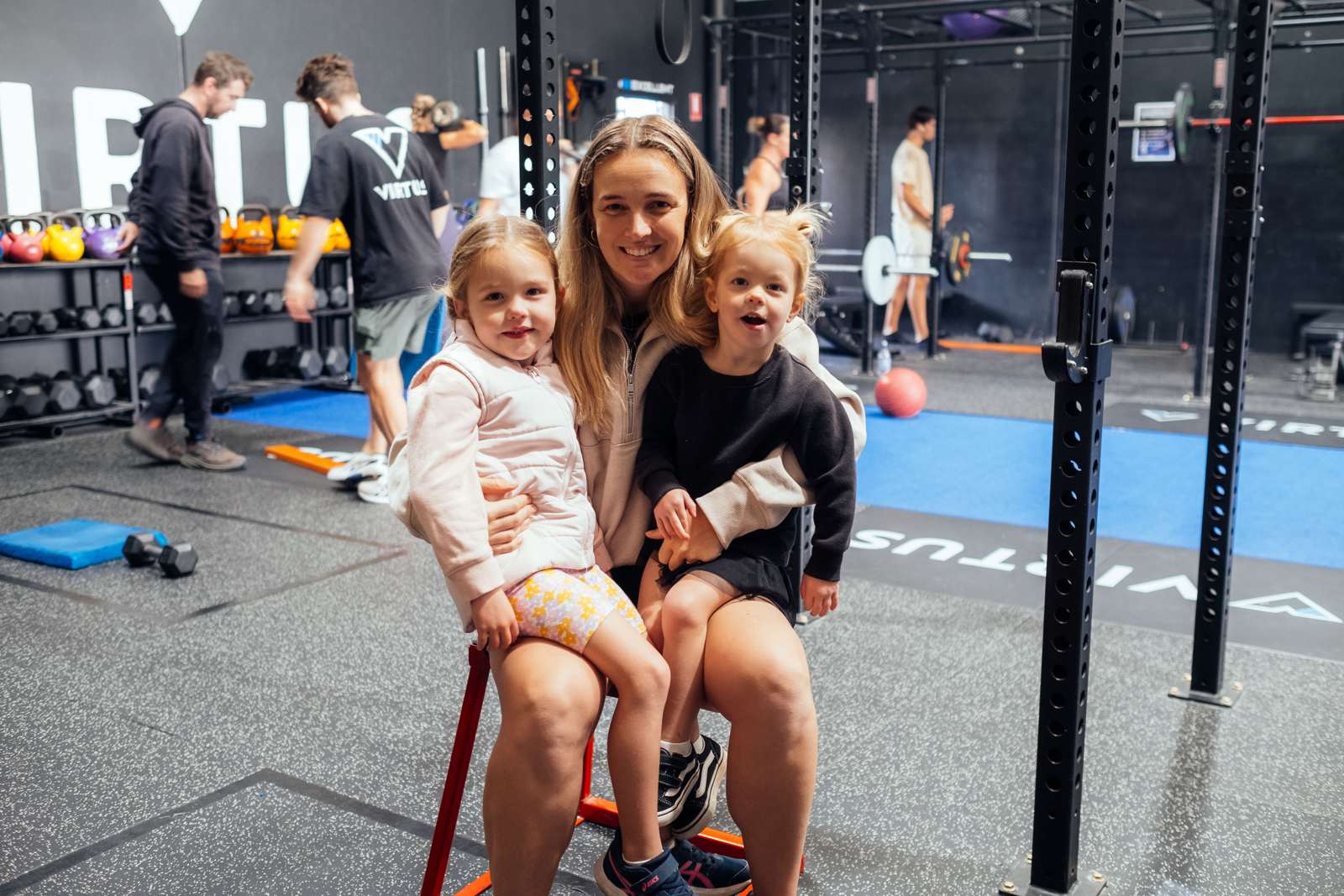 A mum and her two little ones on the plyo box